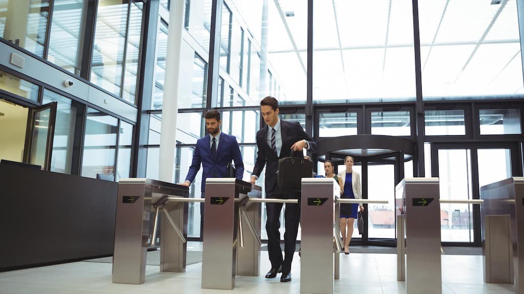 office-working-going-through-security-turnstiles-reception