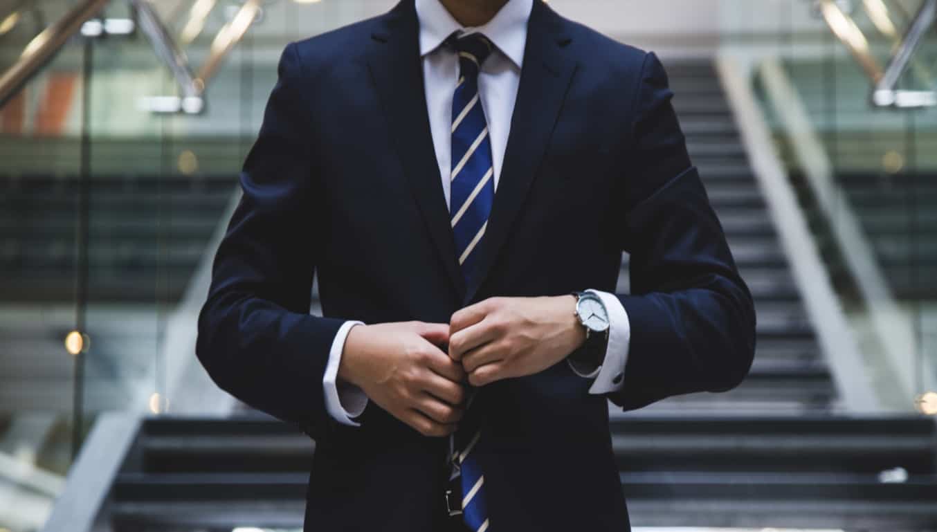 man-buttoning-up-suit-jacket