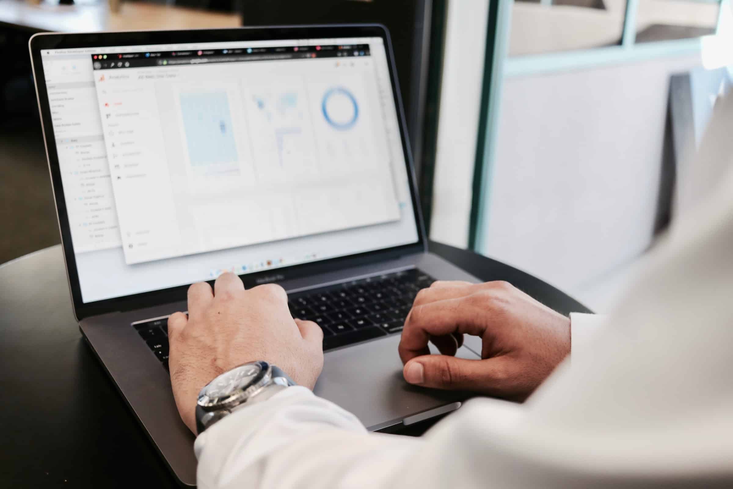 man-looking-at-financial-figures-on-laptop
