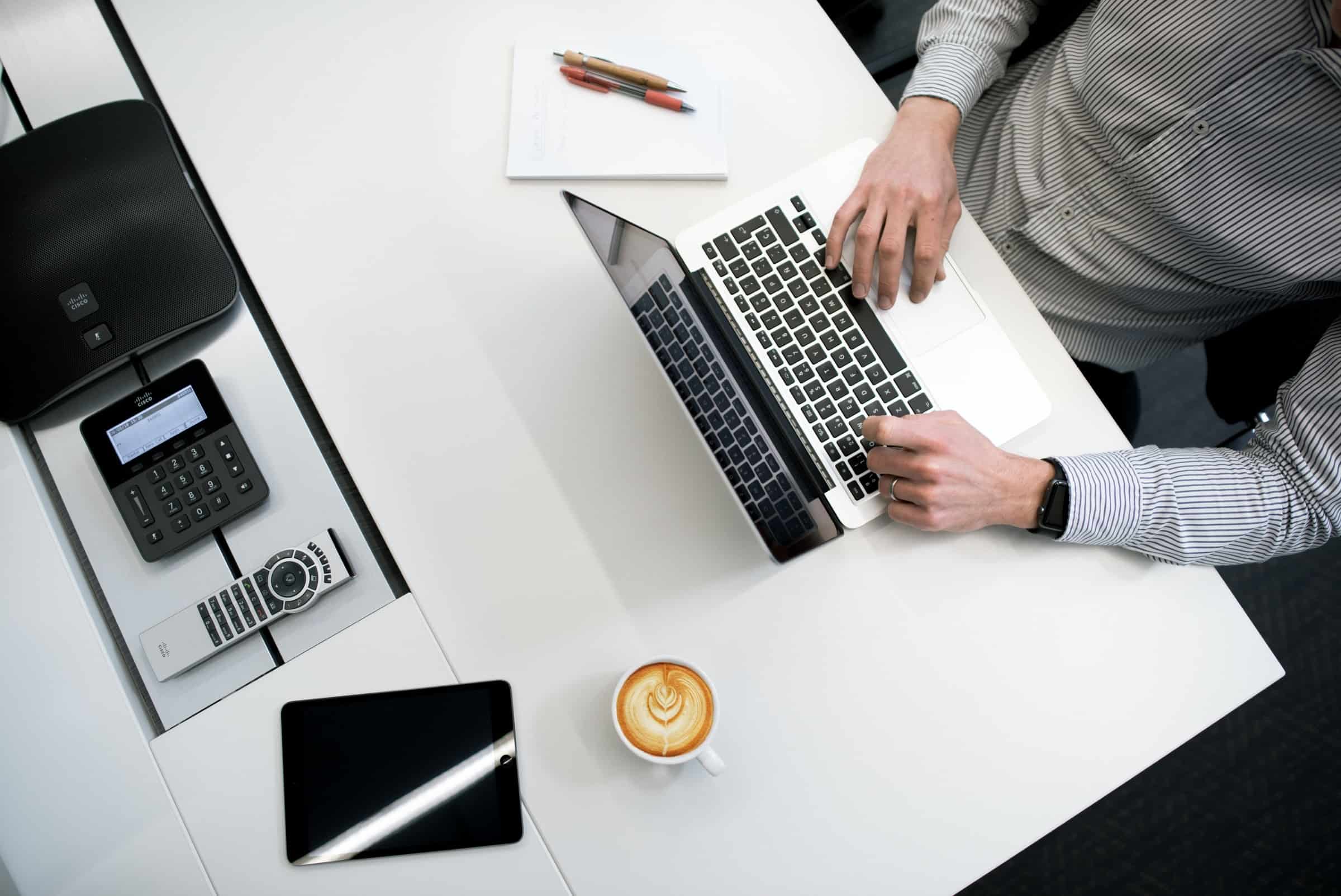 man-working-on-his-laptop-with-a-coffee-calculator