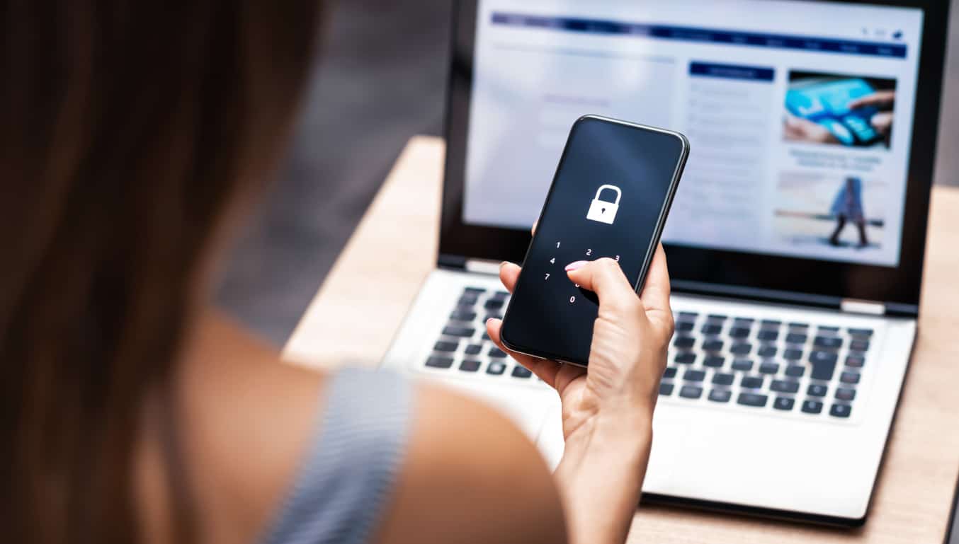 Woman with phone and laptop