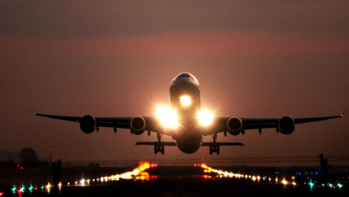 airplane-taking-off-on-runway-sunset