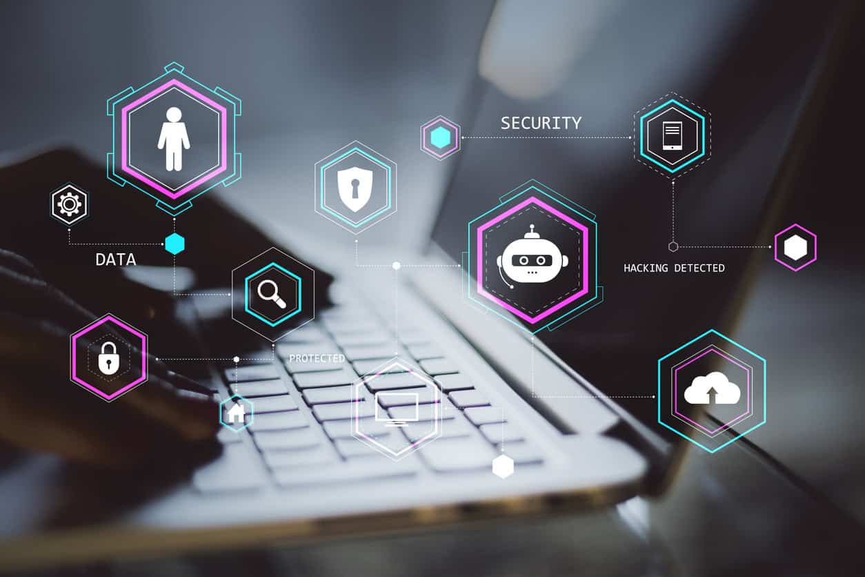 Holographic security icons over laptop keyboard indicating data protection and hacking detection.|