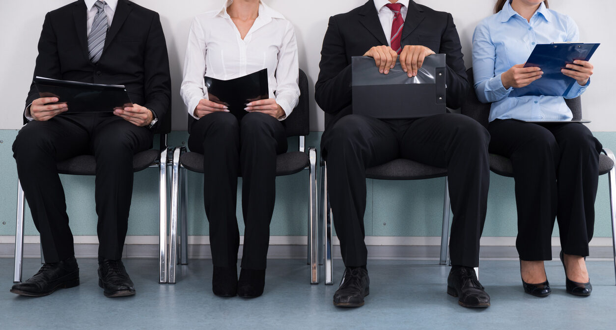 Close-up Of Businesspeople With Files Sitting On Chair|