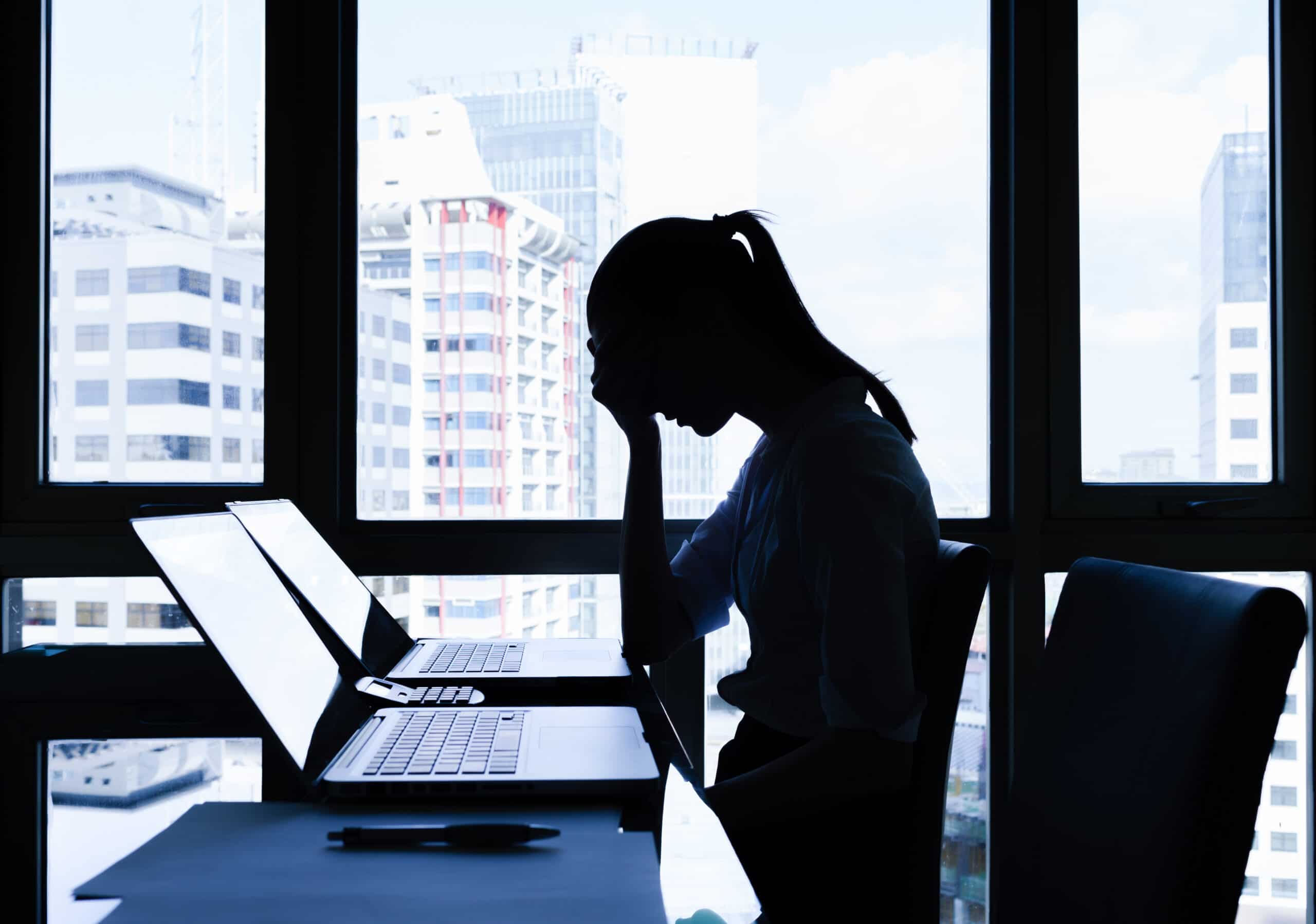 Menopause-Stressed-businesswoman-laptop-head-in-hands