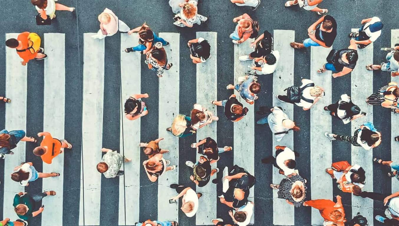 |Aerial. People crowd on pedestrian crosswalk. Top view background. Toned image.