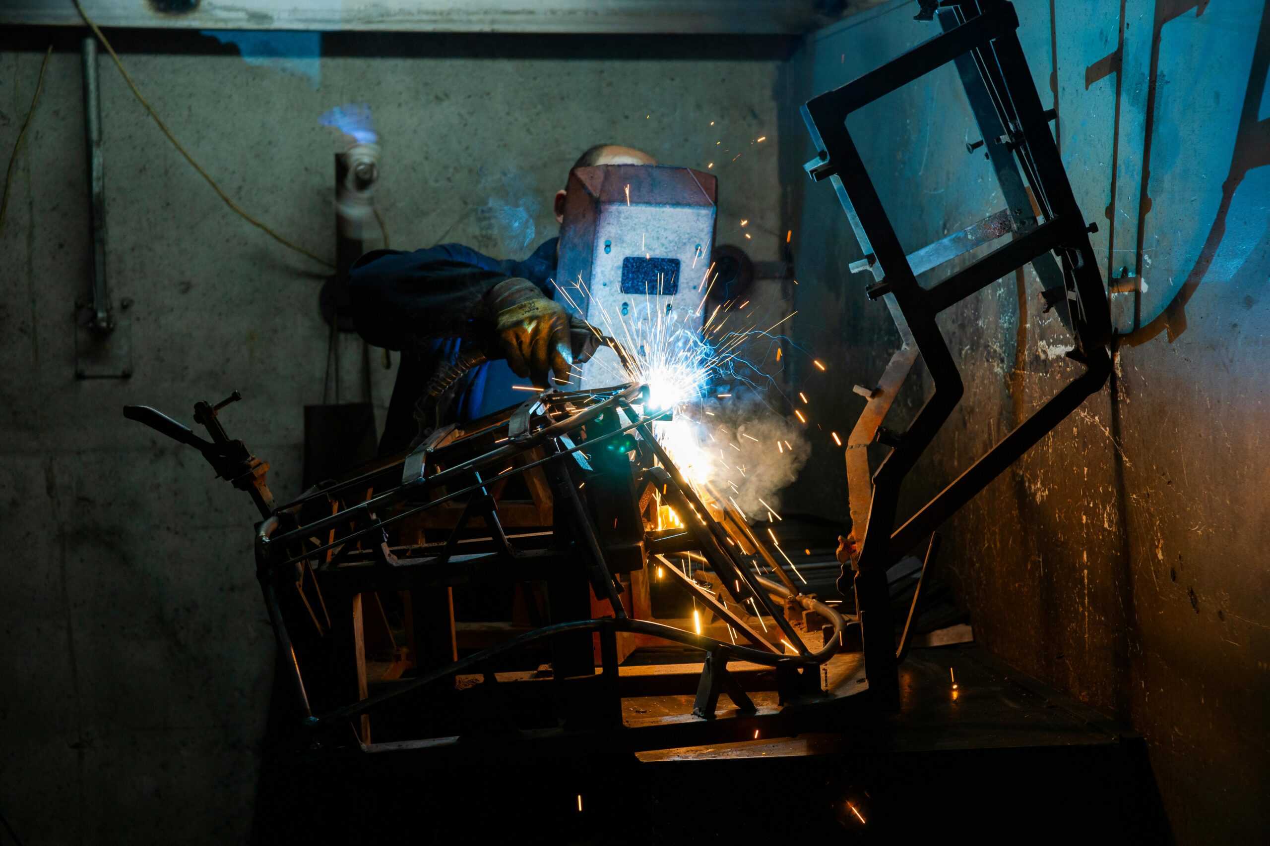 skilled worker - cutting metal with a metal saw.