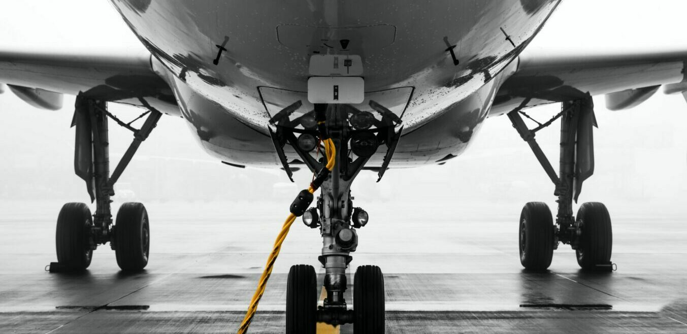 underside of an aeroplane on the runway|aeroplane on runway with the sunset
