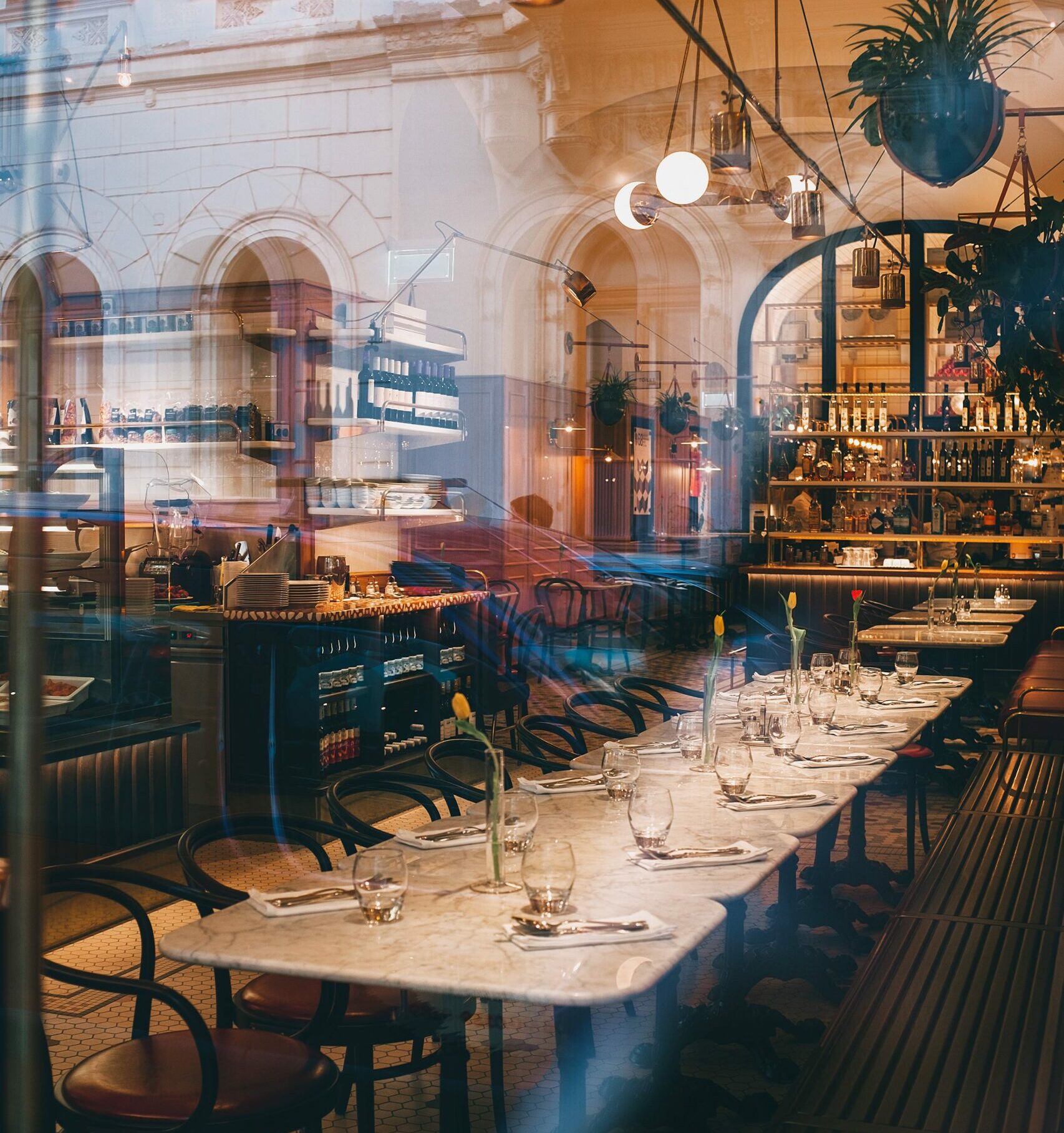 Hospitality - long table with chairs around it in a restaurant.