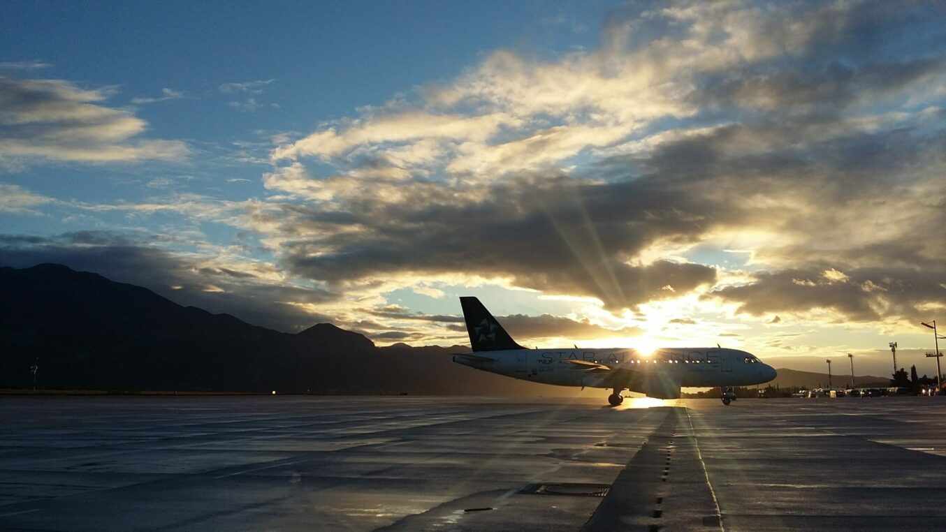 plane on a runway with the sun behind