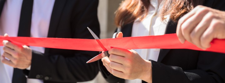 scissors cutting the red tape