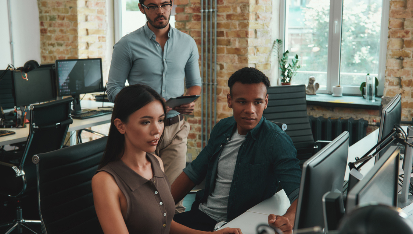 people sat around a computer screen