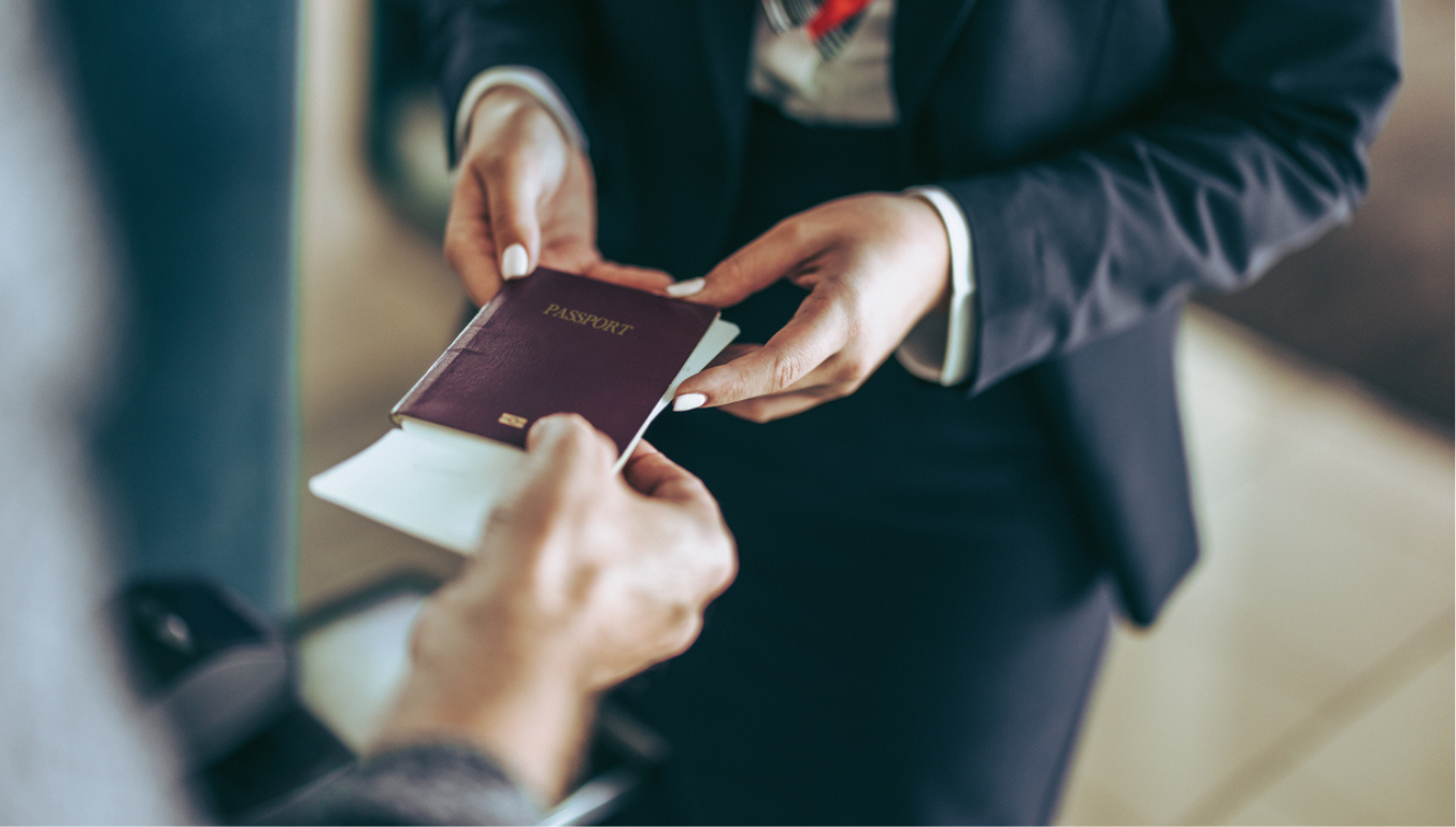 Person handing over a Visa to a pair of hands
