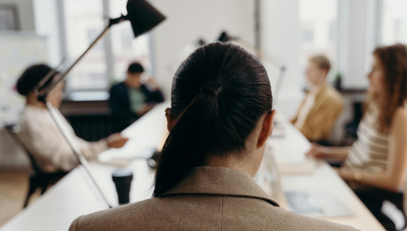 Woman in Brown Coat Sitting on Chair