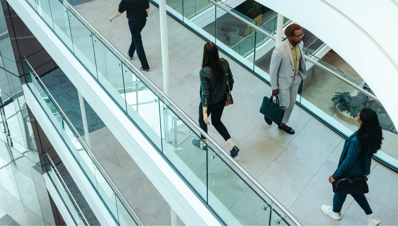 A group of diverse businesspeople walking briskly in a contemporary office space