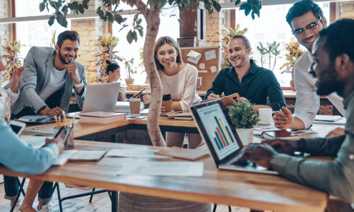 people sat around a work desk chatting