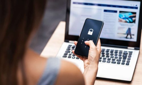 Woman with phone and laptop