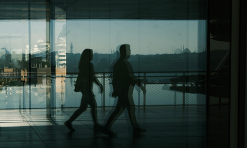people walking - shadows away on a corridor