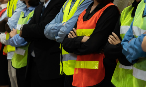 Large group of factory worker standing together in warehouse or storehouse . Logistics , supply chain and warehouse business concept