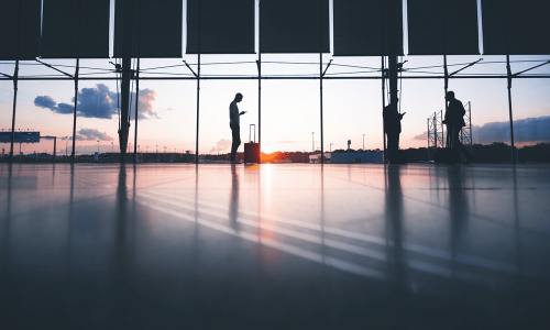 passengers-at-the-airport-with-the-sun-setting