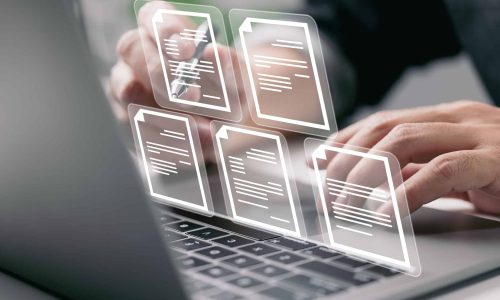 Businessman working on laptop computer with electronics document icons