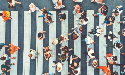|Aerial. People crowd on pedestrian crosswalk. Top view background. Toned image.